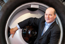 Martin Ritschel sitting inside the wheel rim of a forestry tractor