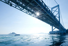 Bridge across water reflecting sunlight