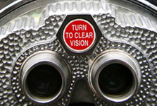 Eyepiece of a telescope bearing the sign "Turn to clear vision"